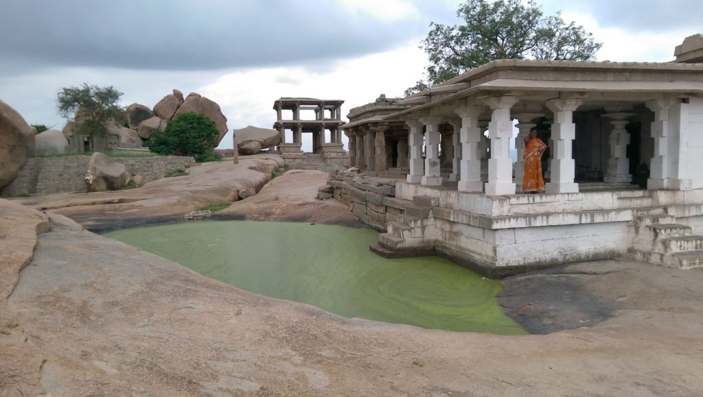 Hampi ruins, green water, woman